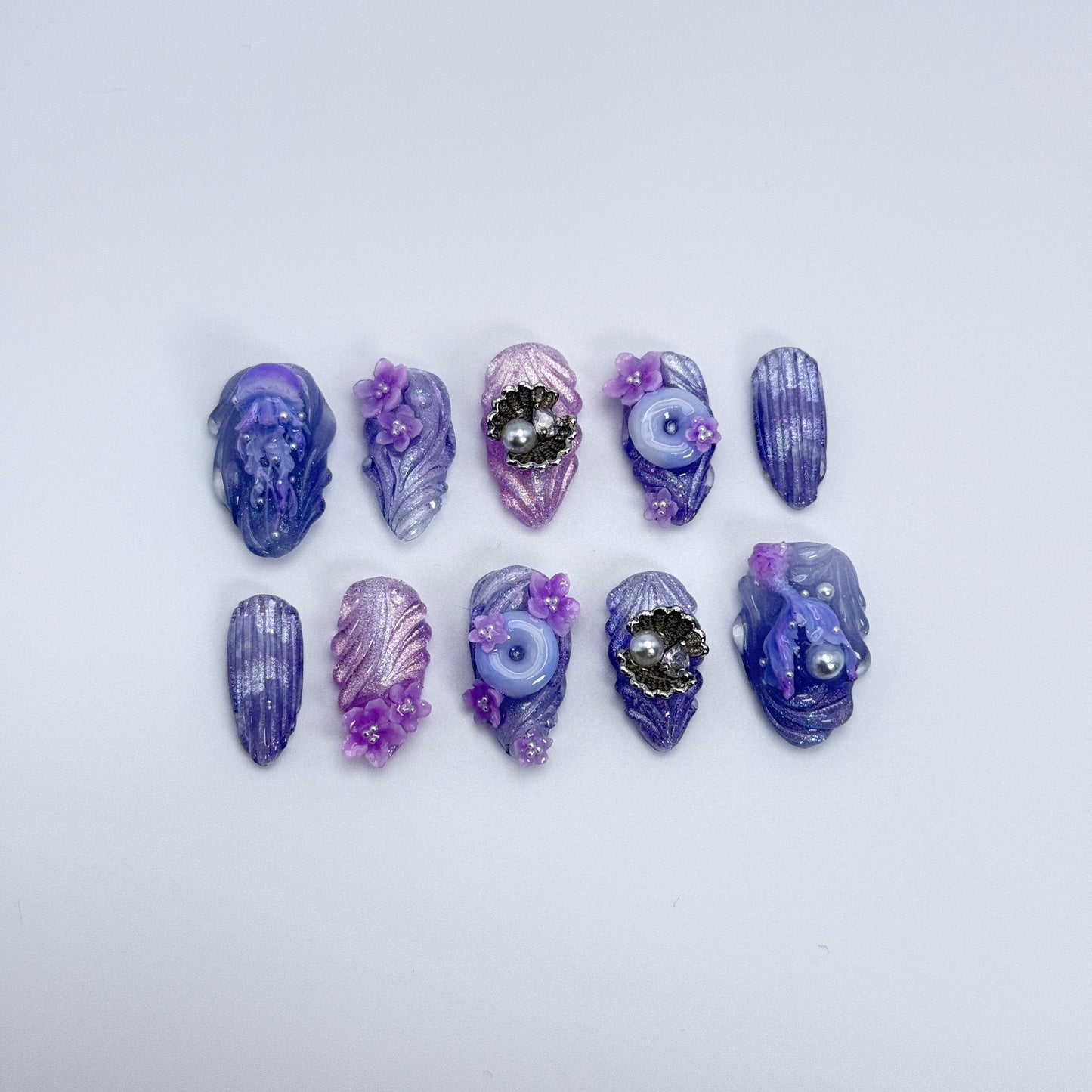 Purple and blue decorative stones on a white background
